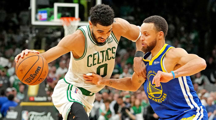 Jun 16, 2022; Boston, Massachusetts, USA; Boston Celtics forward Jayson Tatum (0) handles the ball against Golden State Warriors guard Stephen Curry (30) during the fourth quarter in game six of the 2022 NBA Finals at TD Garden.